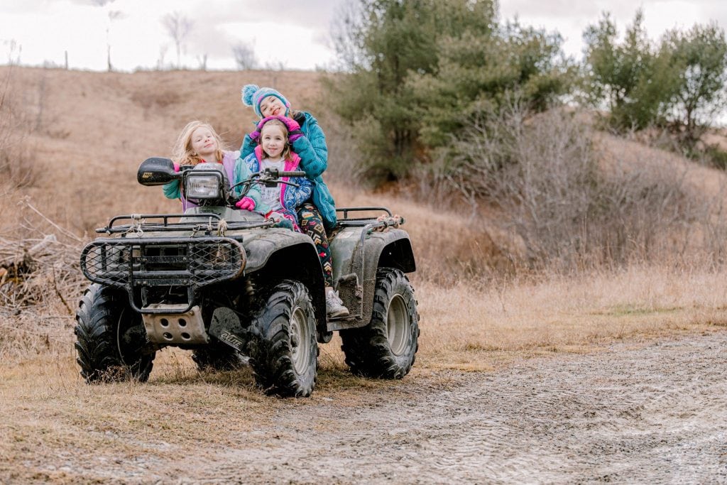 girls on 4-wheeler, coats on 