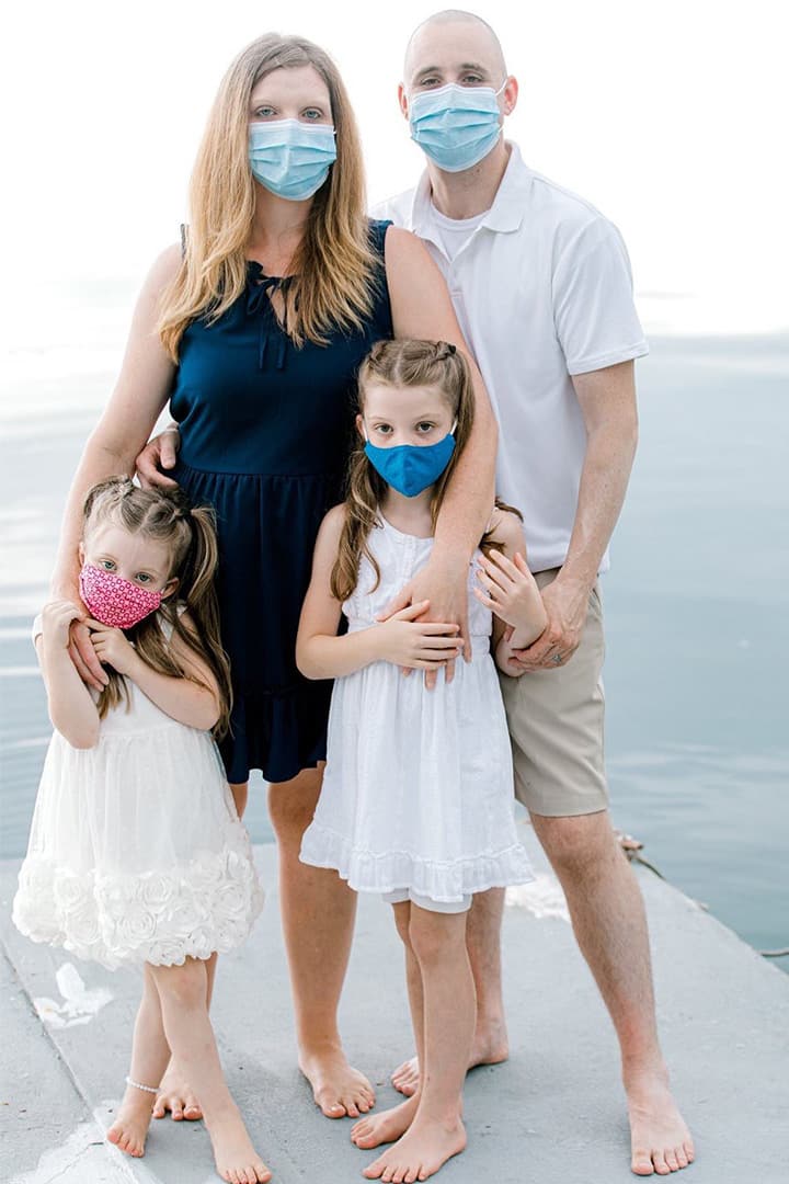 family in facemasks on water