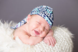 Baby girl, smile, newborn hat, basket fluff, baby