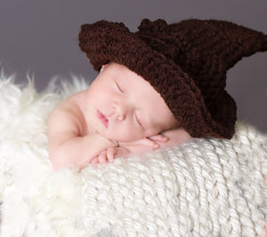 newborn girl with Harry Potter wizard hat