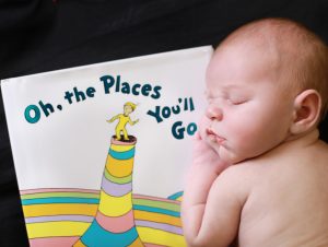 newborn baby on stomach sleeping on Dr. Seuss book 