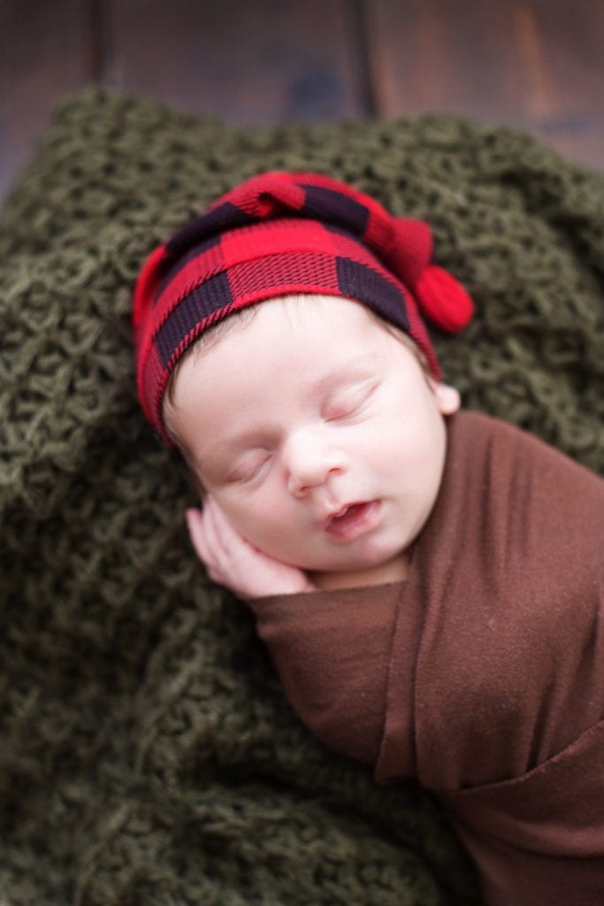 Newborn Photo Session, newborn brown wrap, plaid red hat, forest green blanket, 