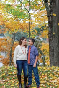 mother and son looking at each other outside in the fall