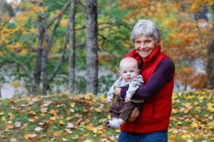 grandmother with her newborn grandson in the fall