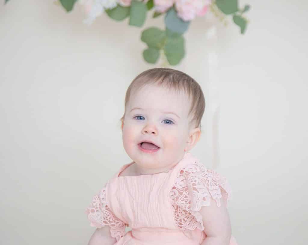 One year old girl looking at the camera smiling