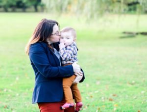 mom kissing her baby boy in the park