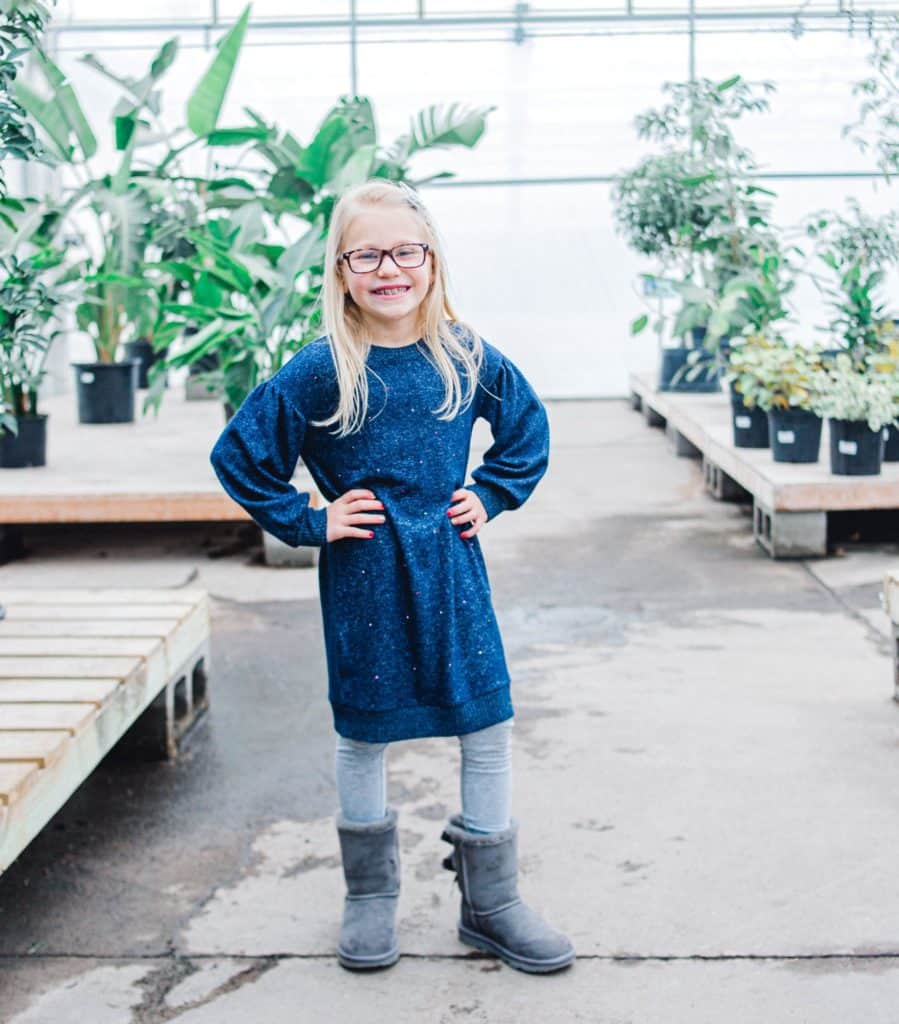 Maine girl in greenhouse looking at the camera