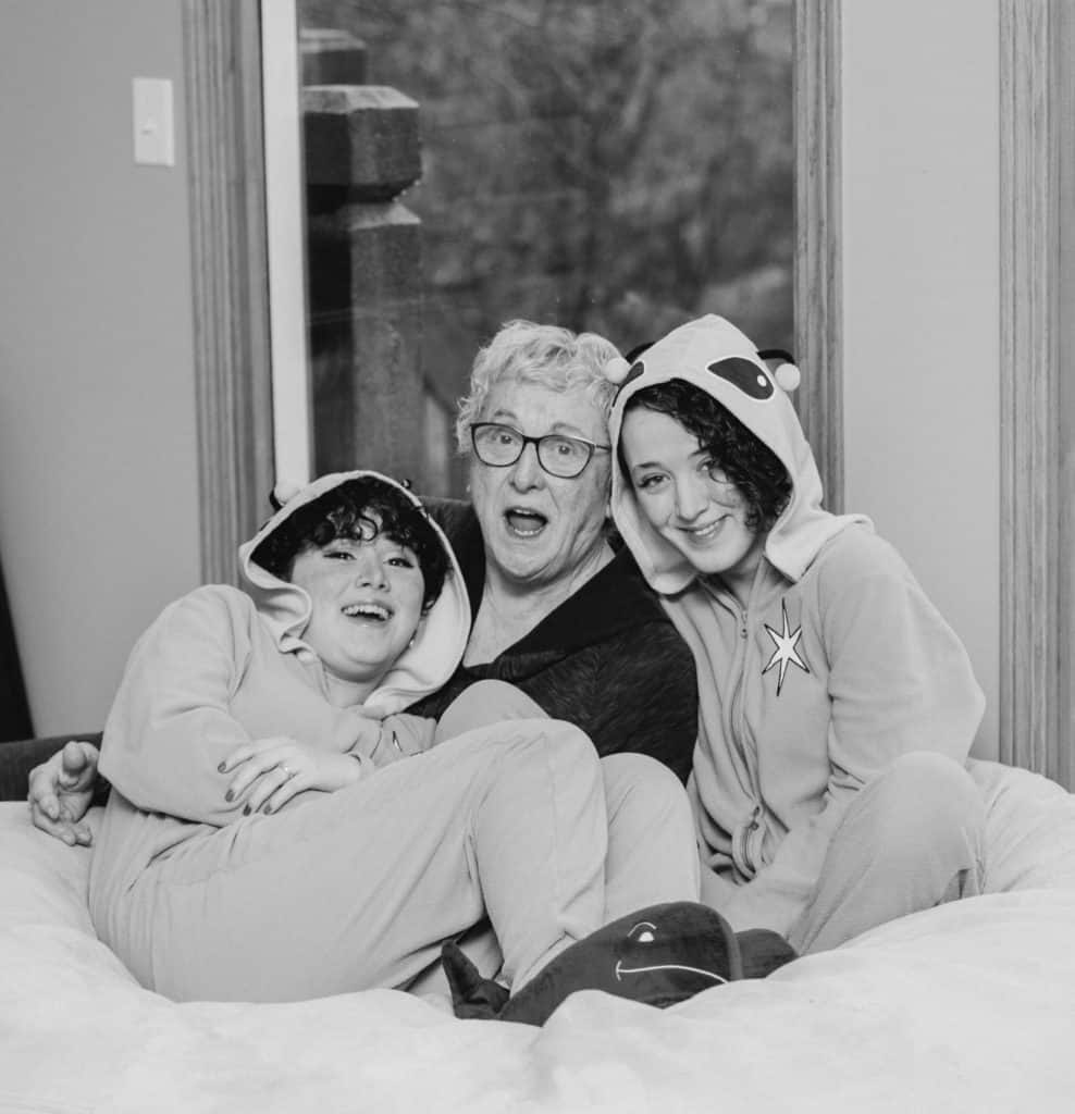 grandmother and granddaughters sitting on the bean bag in black and white