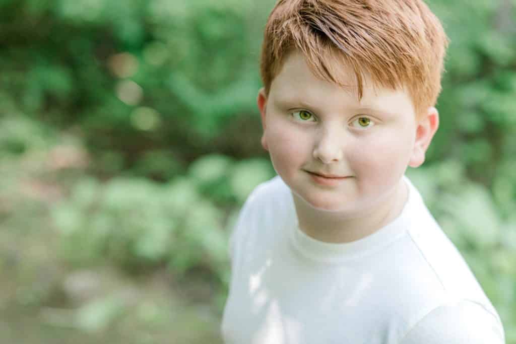 red haired boy looking at the camera