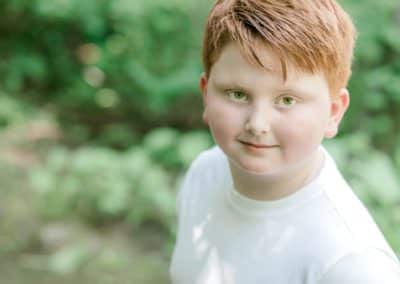 red haired boy looking at the camera