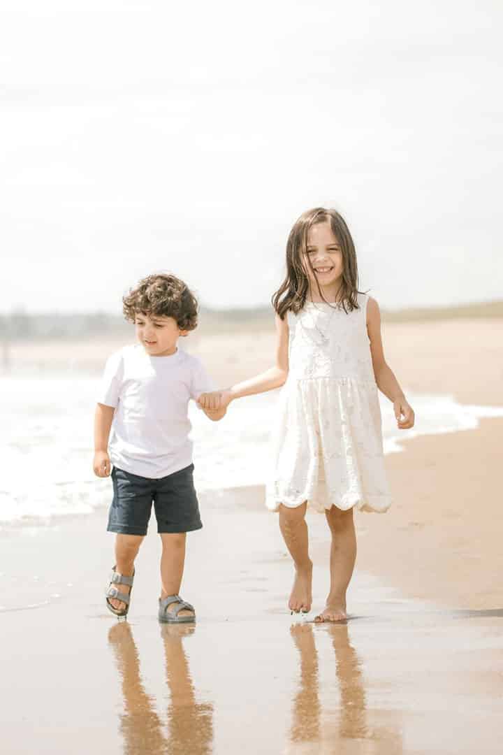 children walking on maine beach
