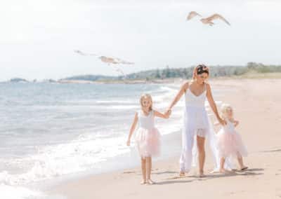 mother and daughters on maine beach