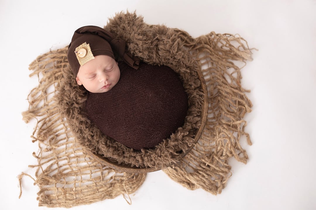 newborn baby snuggle in blanket sleeping in maine