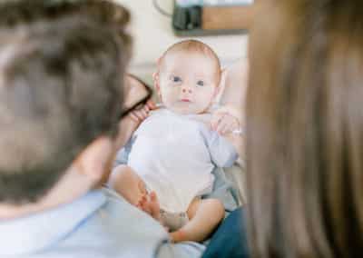 newborn looking at parents