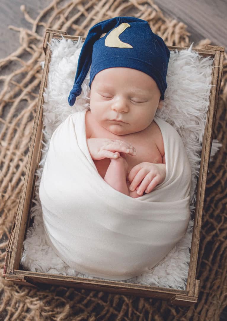 newborn sleeping in basket