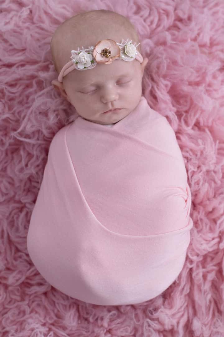 pink-baby newborn flower headband wrapped in blanket