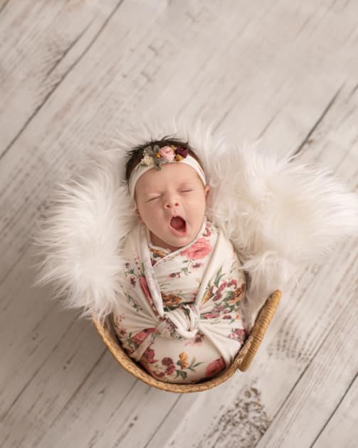 Baby photographer in maine, yawning newborn girl, posed studio newborn