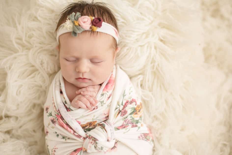 baby photographer in maine, wrapped newborn, floral prints, newborn girl in augusta maine studio 