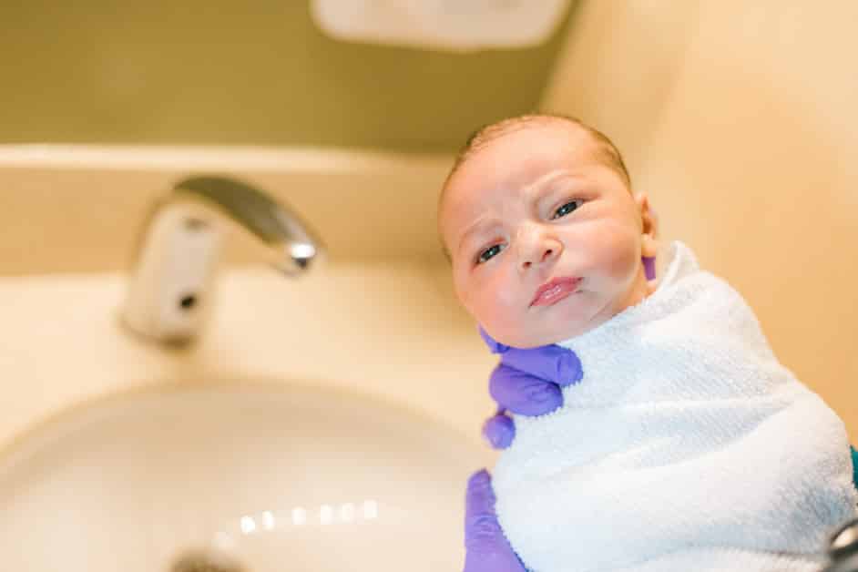 newborn boy, babys first bath in the hospital 