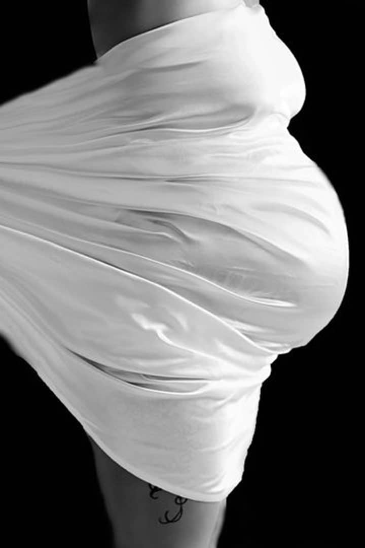 maine maternity photographer black and white with sheet over belly
